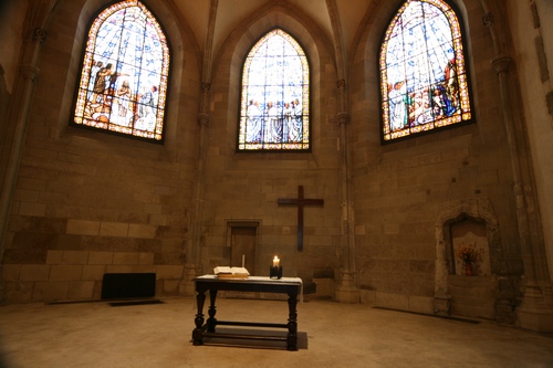 A lit candle in a Geneva church