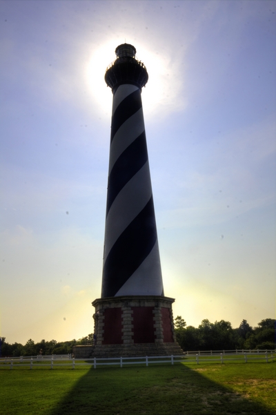Sun shining behind Cape Hatteras Lighthouse